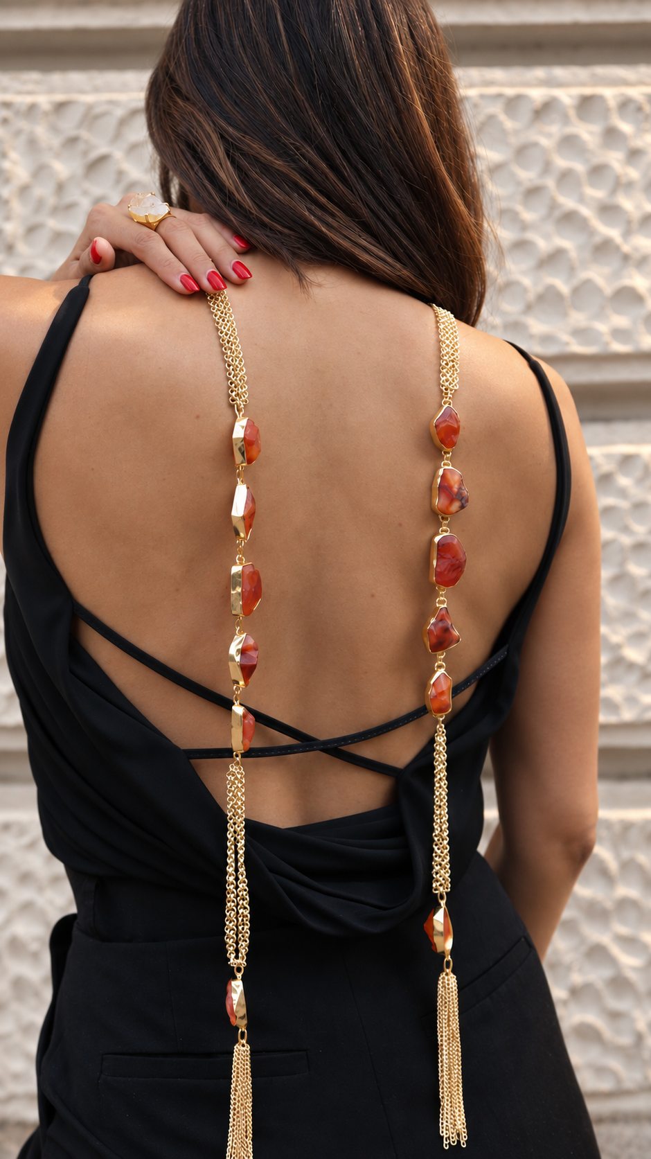 Carnelian convertible necklace draped down the model’s back